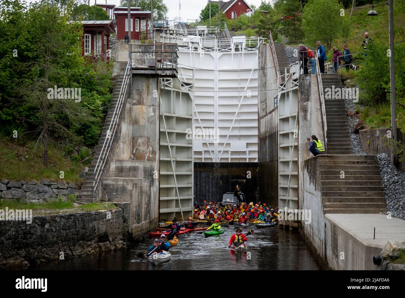 Brekke 20220529.60 colorful kayaks paddling through the locks of the Halden Canal on Sunday. With its 26.6 m total lifting height in four chambers, Brekke locks are Northern Europe's highest continuous lock staircase. After a two-year pandemic break, there is a record-breaking participation in the annual 57 km long paddle trip from Oerje to Halden. Photo: Heiko Junge / NTB Stock Photo