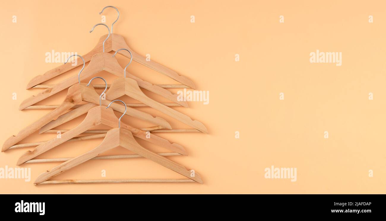 Hangers for clothes. Hanger set. Beige background copy space banner