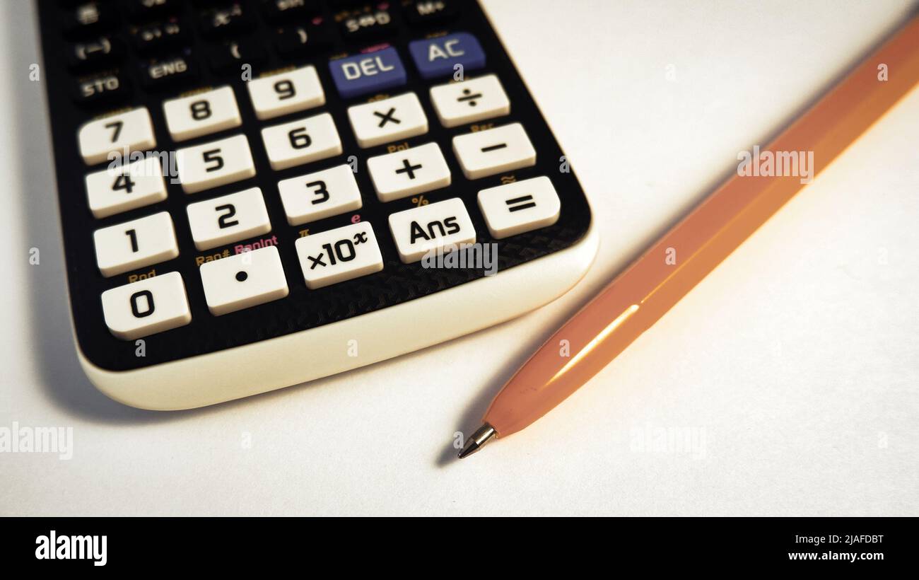 Engineering calculator keyboard and yellow ballpoint pen Stock Photo