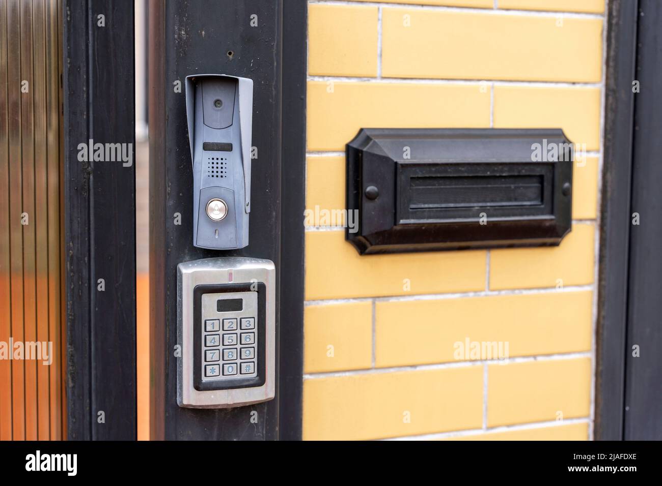 intercom panel with a video camera on the brick fence of private house ...