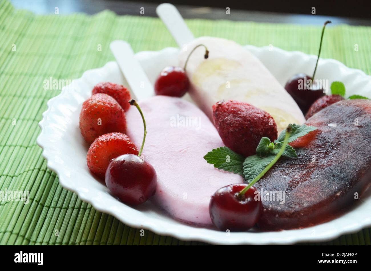 Homemade strawberry cherry banana blueberry ice cream or popsicles