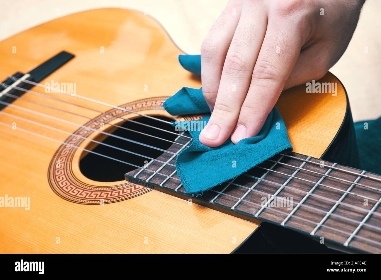 Cleaning the guitar. Musical instrument care. Proper guitar maintenance Stock Photo