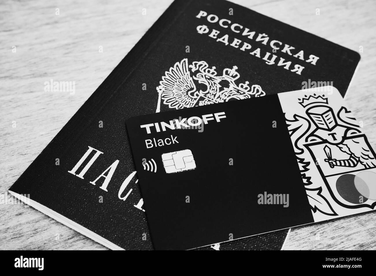 Ryazan, Russia - May 16, 2022: Tinkoff bank credit card lies on a Russian passport Stock Photo