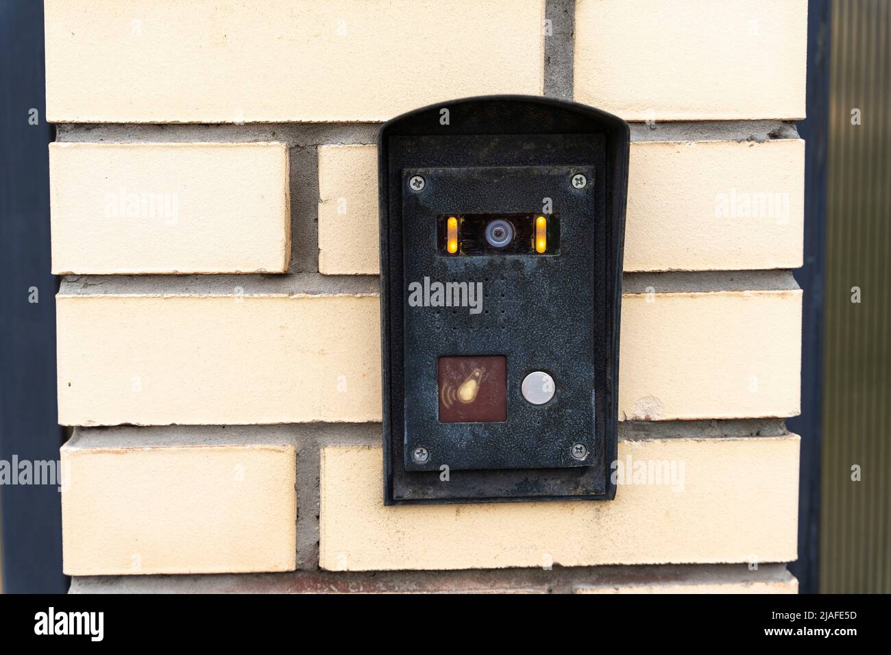 intercom panel with a video camera on the brick fence of private house Stock Photo
