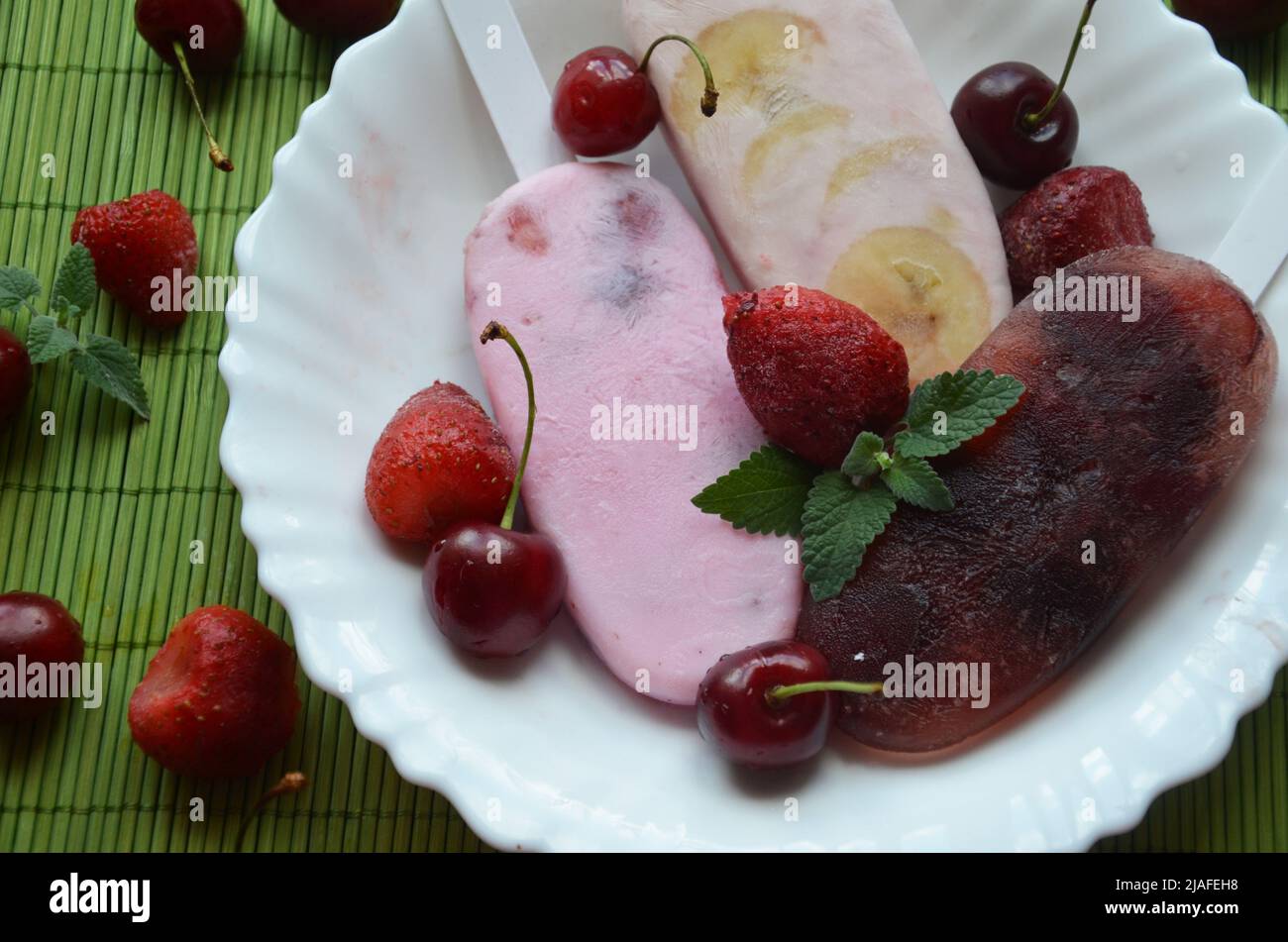 Homemade strawberry cherry banana blueberry ice cream or popsicles