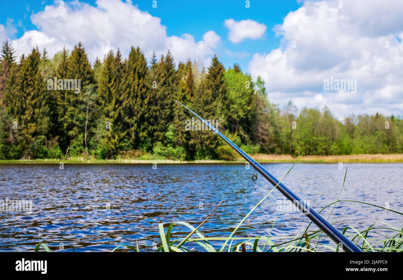 Fishing rod on the background of the river. Fishing. Waiting for fish Stock Photo