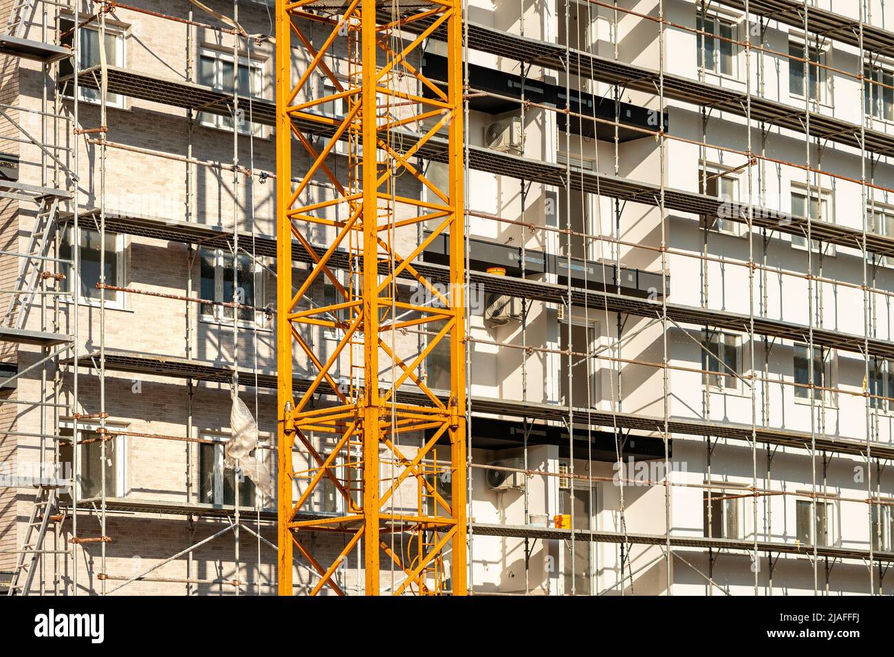 Real estate development, residential apartment building construction site with scaffolding Stock Photo
