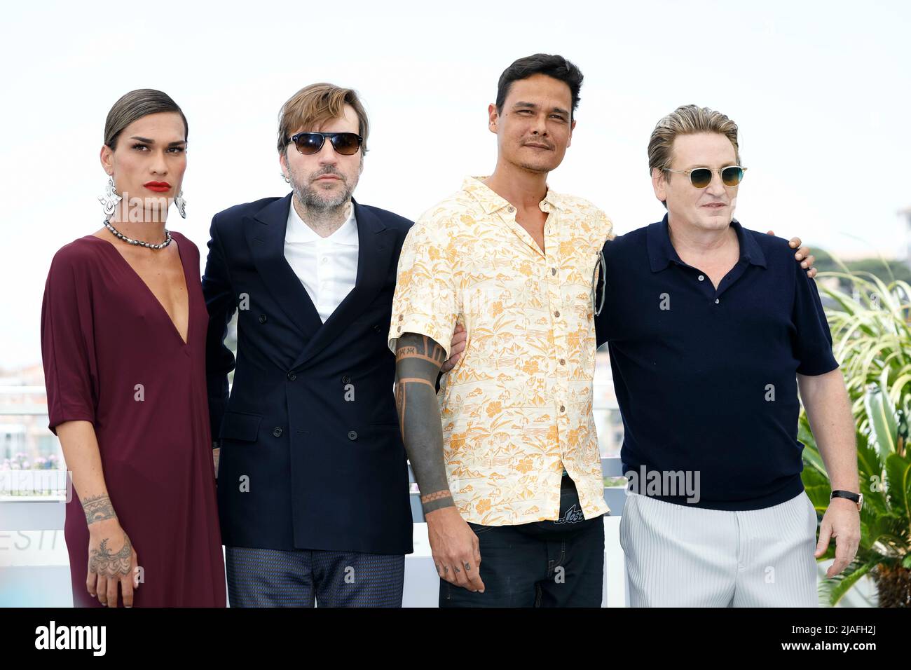 Pahoa Mahagafanau (Shanna) (l-r), Albert Serra, Matahi Pambrun and Benoit Magimel pose at the photocall of 'Pacification' during the 75th Cannes Film Festival, Festival de Cannes, at Palais des Festivals in Cannes, France, on 27 May 2022. Stock Photo