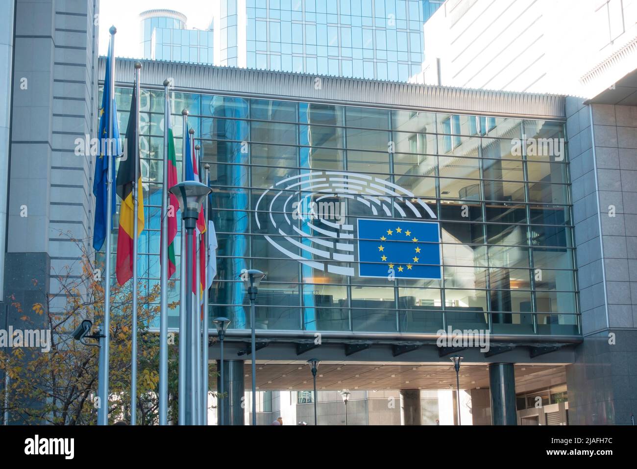 Brussels, Belgium - Nov 17, 2019: European Parliament building in Brussels. Emblem of the EU and EU countries flags. Stock Photo