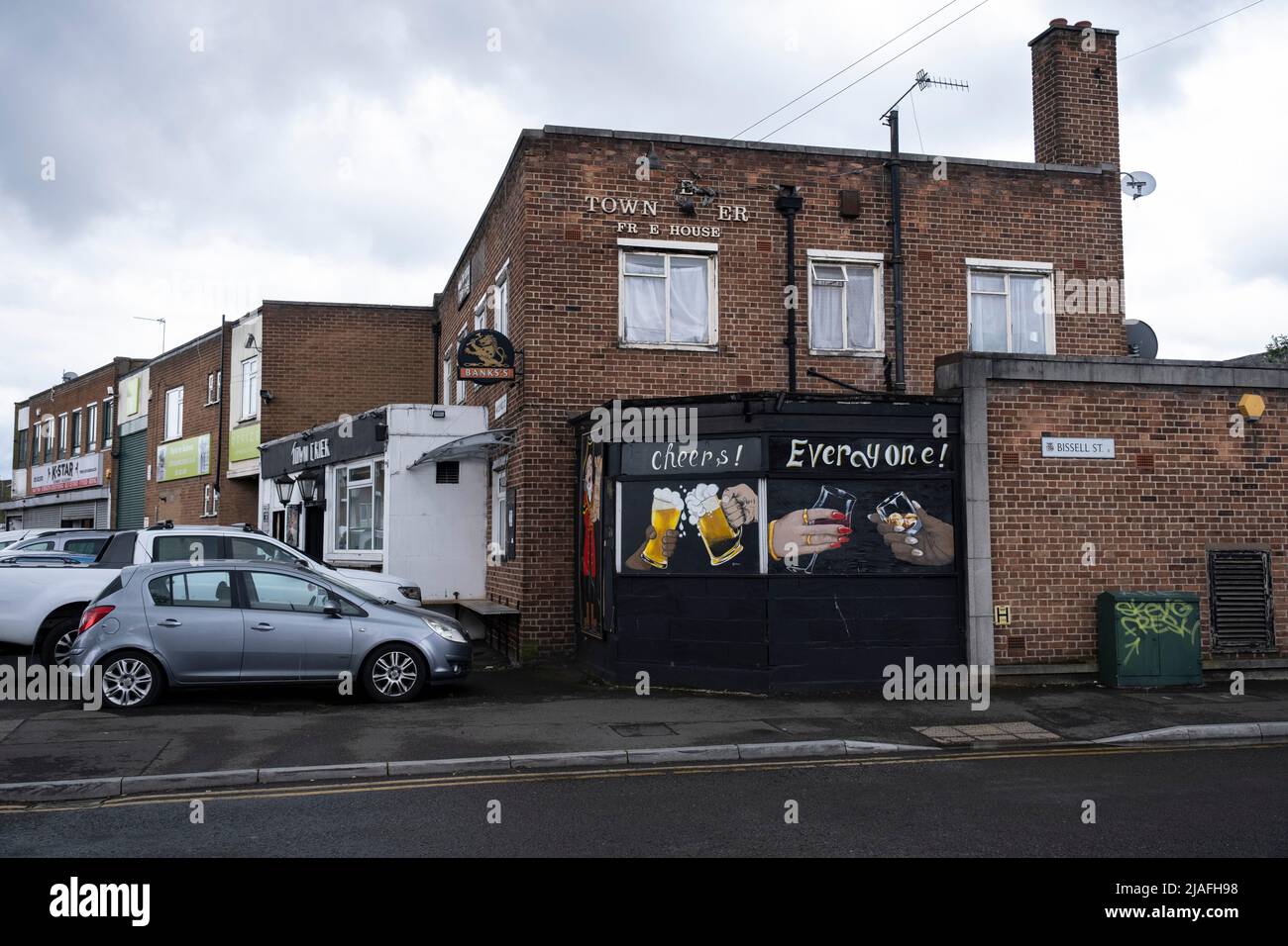 The Town Crier pub with welcoming cheers sign painted on the exterior depicting two beer glasses together in Deritend on 4th May 2022 in Birmingham, United Kingdom. Stock Photo