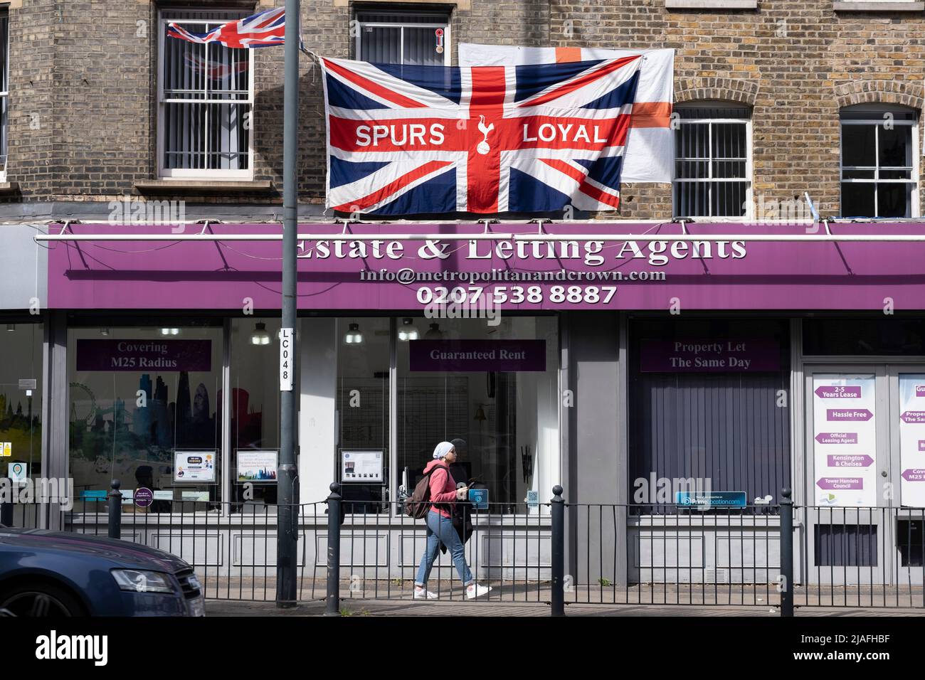 Spurs loyal Union Jack flag hanging from a flat above shops on 18th May 2022 in East London, United Kingdom. Tottenham Hotspur Football Club, commonly referred to as Spurs, is an English professional football club based in Tottenham, that competes in the Premier League. Stock Photo