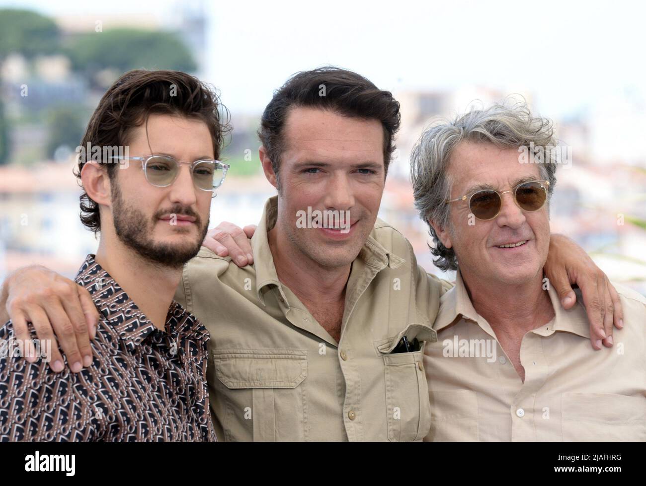May 28, 2022, CANNES, France: CANNES, FRANCE - MAY 28: Pierre Niney, Nicolas Bedos and FranÃ§ois Cluzet attend the photocall for ''Mascarade'' during the 75th annual Cannes film festival at Palais des Festivals on May 28, 2022 in Cannes, France. (Credit Image: © Frederick Injimbert/ZUMA Press Wire) Stock Photo