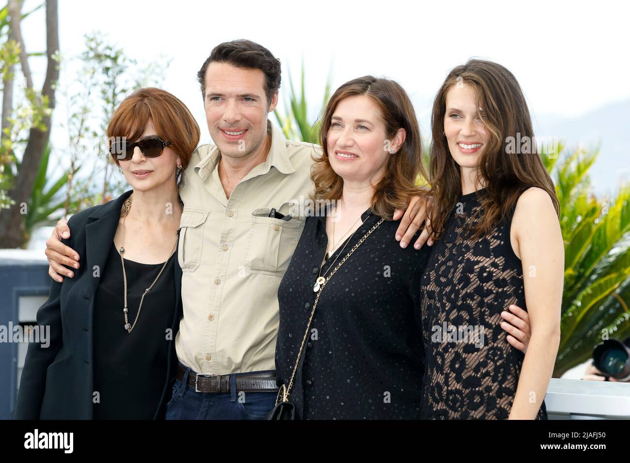 Laura Morante (l-r), Nicolas Bedos, Emmanuelle Devos and Marine Vacth pose at the photocall of 'Masquerade' during the 75th Cannes Film Festival at Palais des Festivals in Cannes, France, on 28 May 2022. Stock Photo