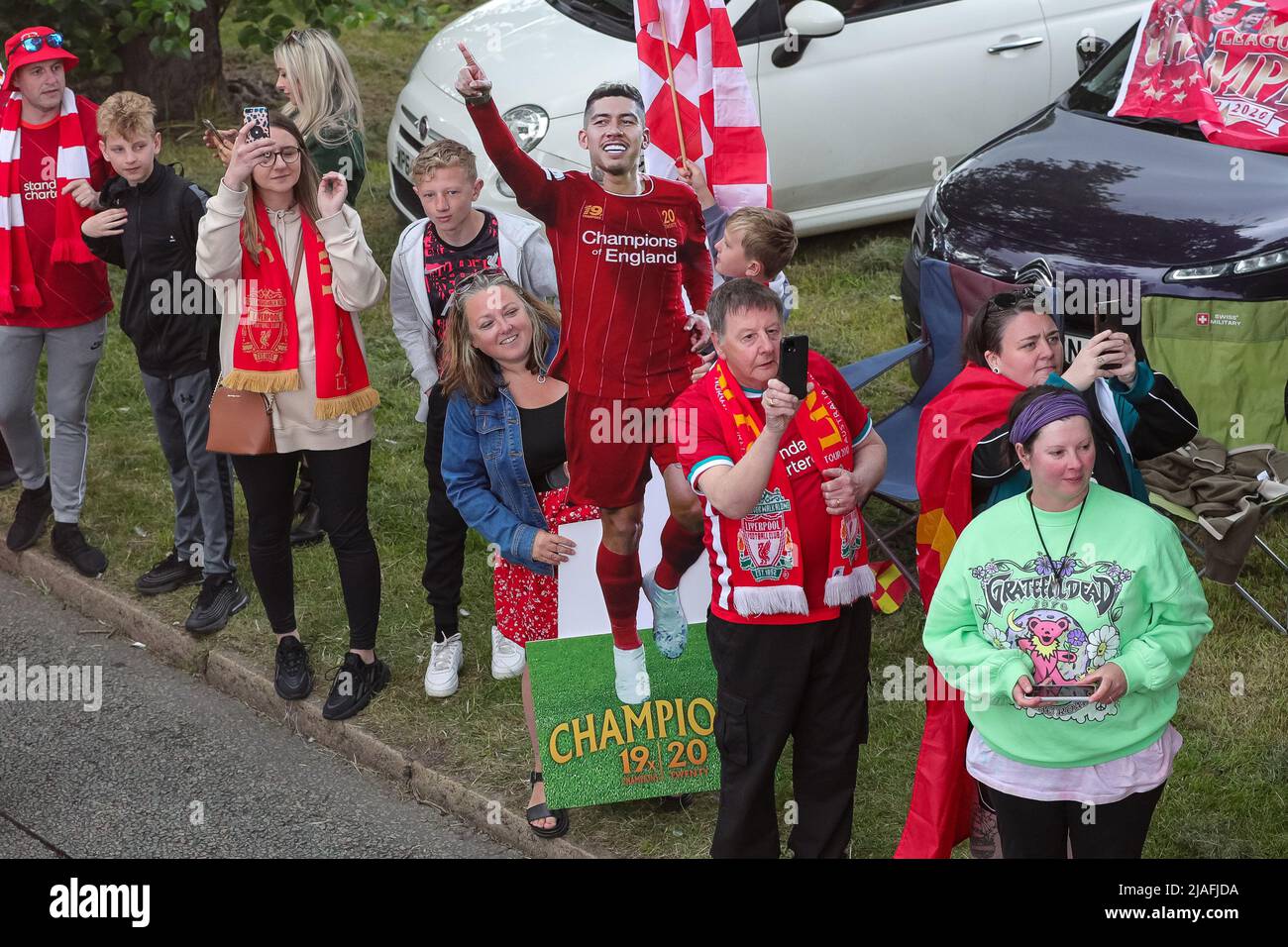 A cardboard cutout of Roberto Firmino is held up by a fan as the