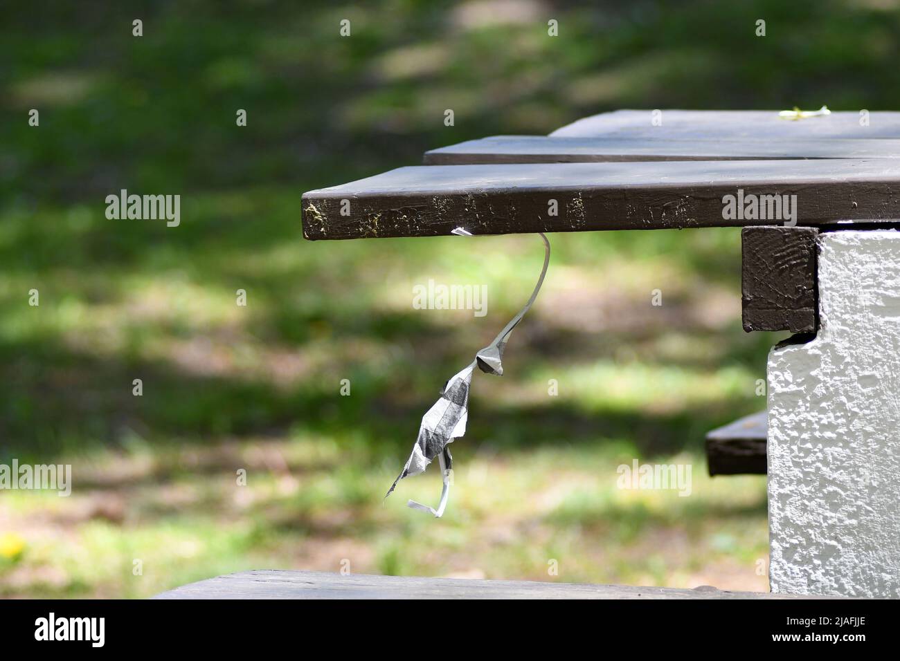 HANGMAN: A character created out of paper dangles by the neck from a picnic table simulating the hanging of a man in Menlo park of Edison, New Jersey. Stock Photo