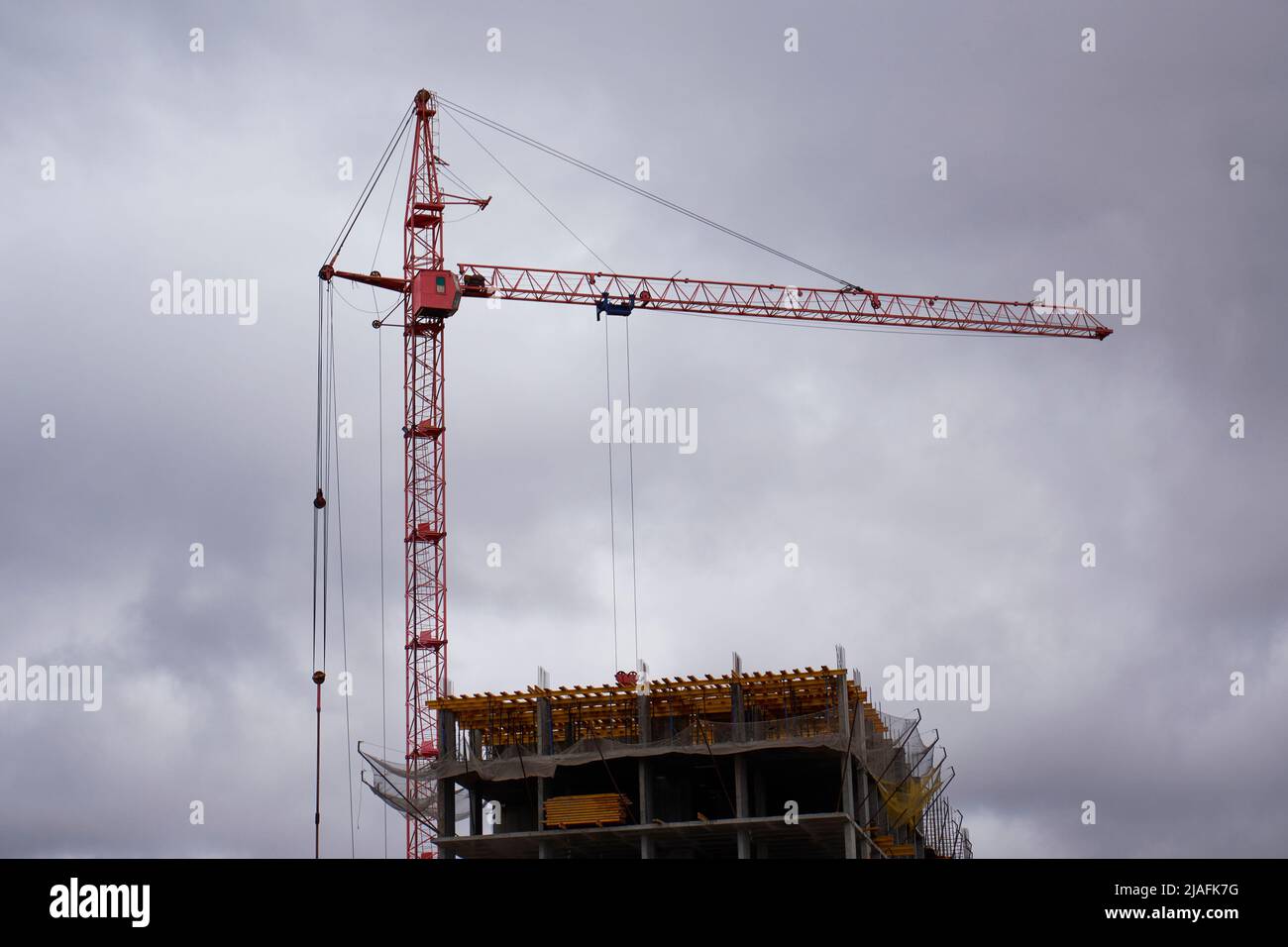 Construction crane on the background of the cloudy sky Stock Photo - Alamy