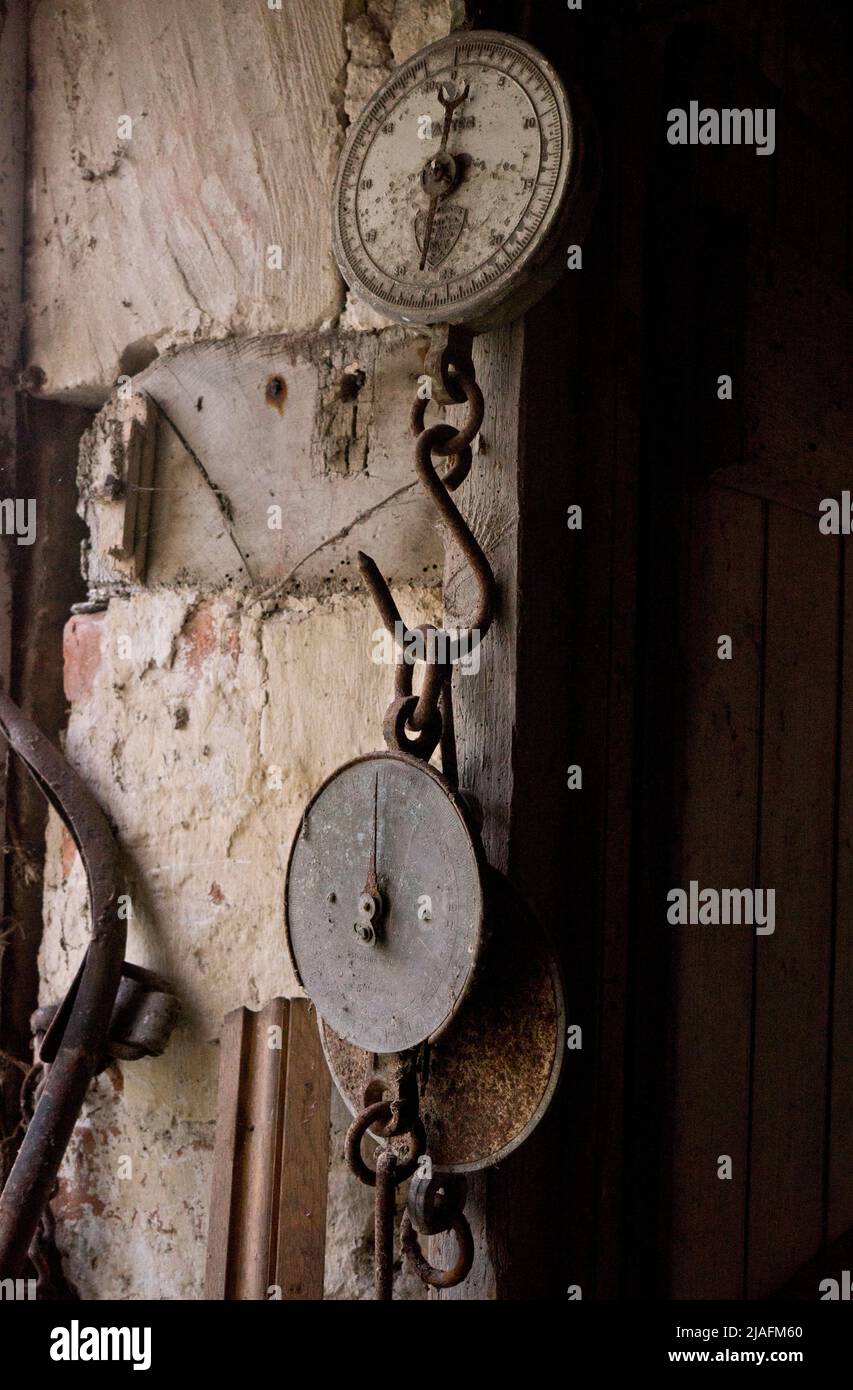 INTERIOR OF STORAGE ROOM WITH OLD FURNITURE AND SIGNS AT A FARM BY RIVER IN WILTSHIRE, ENGLAND