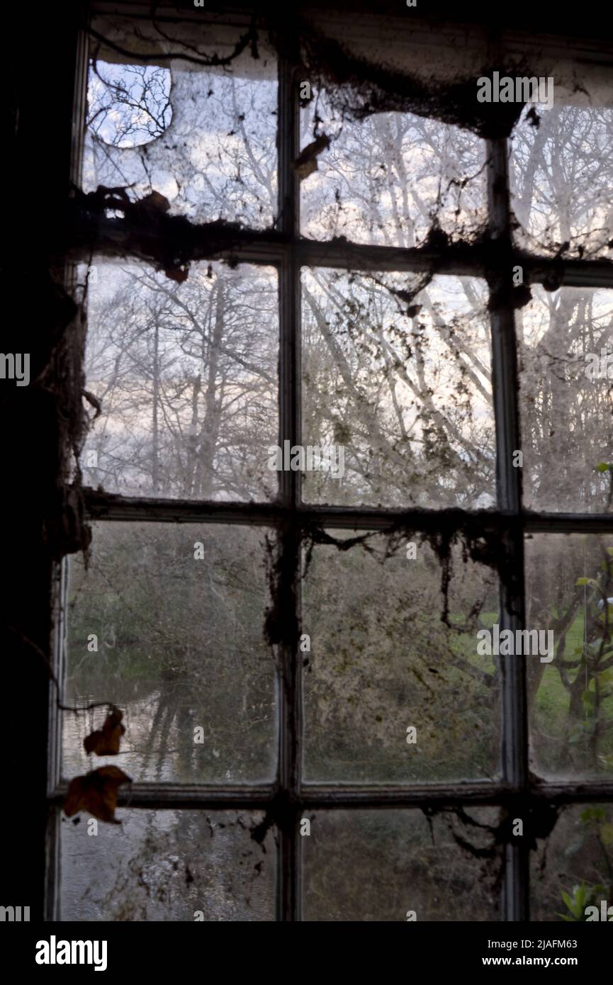 INTERIOR OF STORAGE ROOM WITH OLD FURNITURE AND SIGNS AT A FARM BY RIVER IN WILTSHIRE, ENGLAND