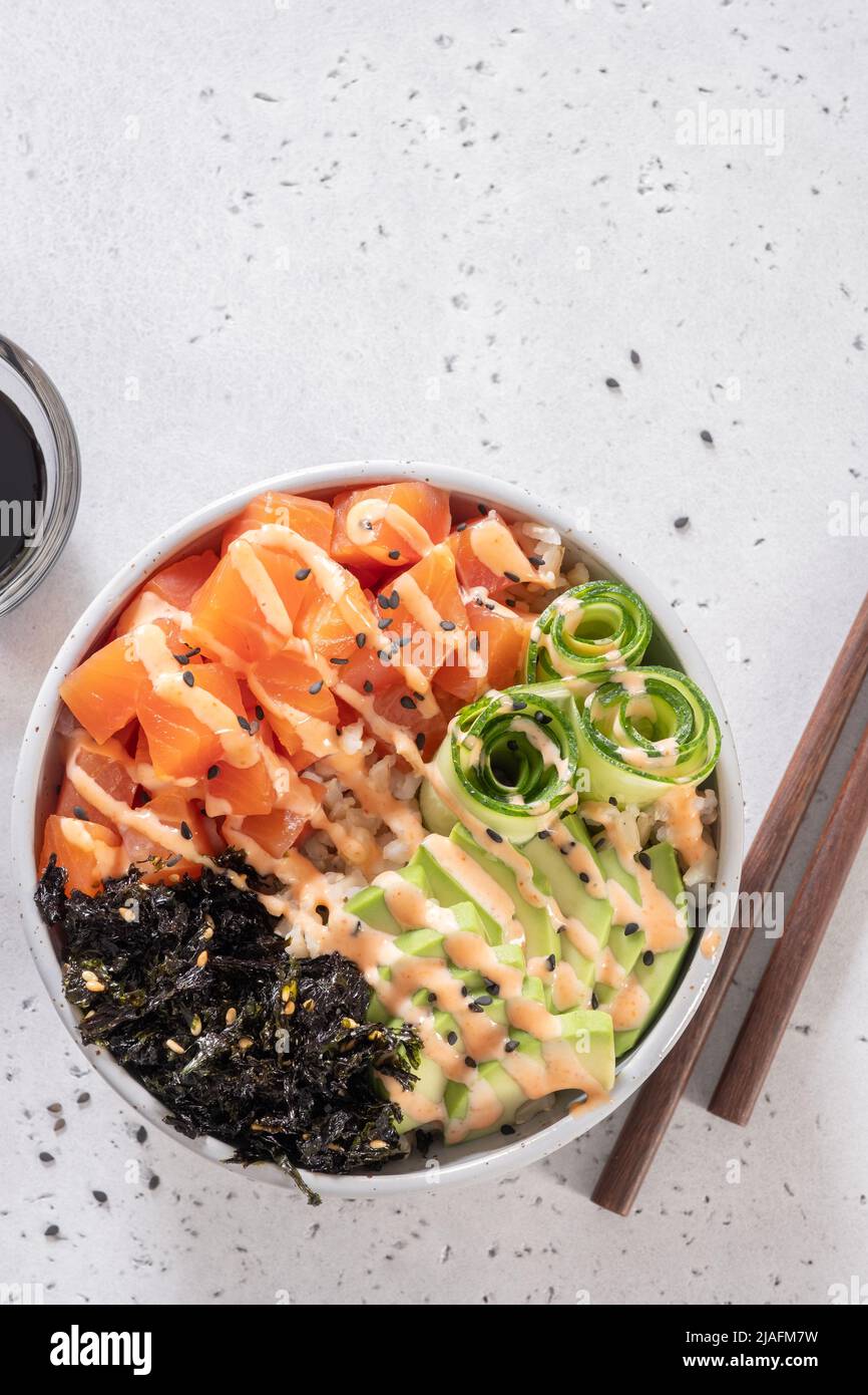 Hawaiian Salmon Poke Bowl with avocado, cucumber, rice and sesame seeds