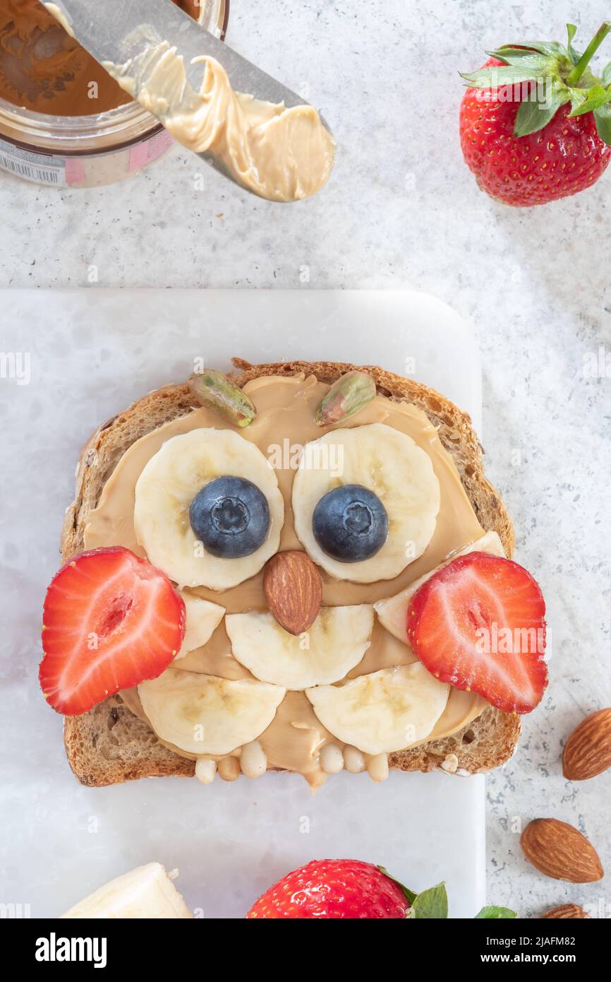 Kids breakfast toast with peanut butter spread, banana, strawberry Stock Photo Alamy