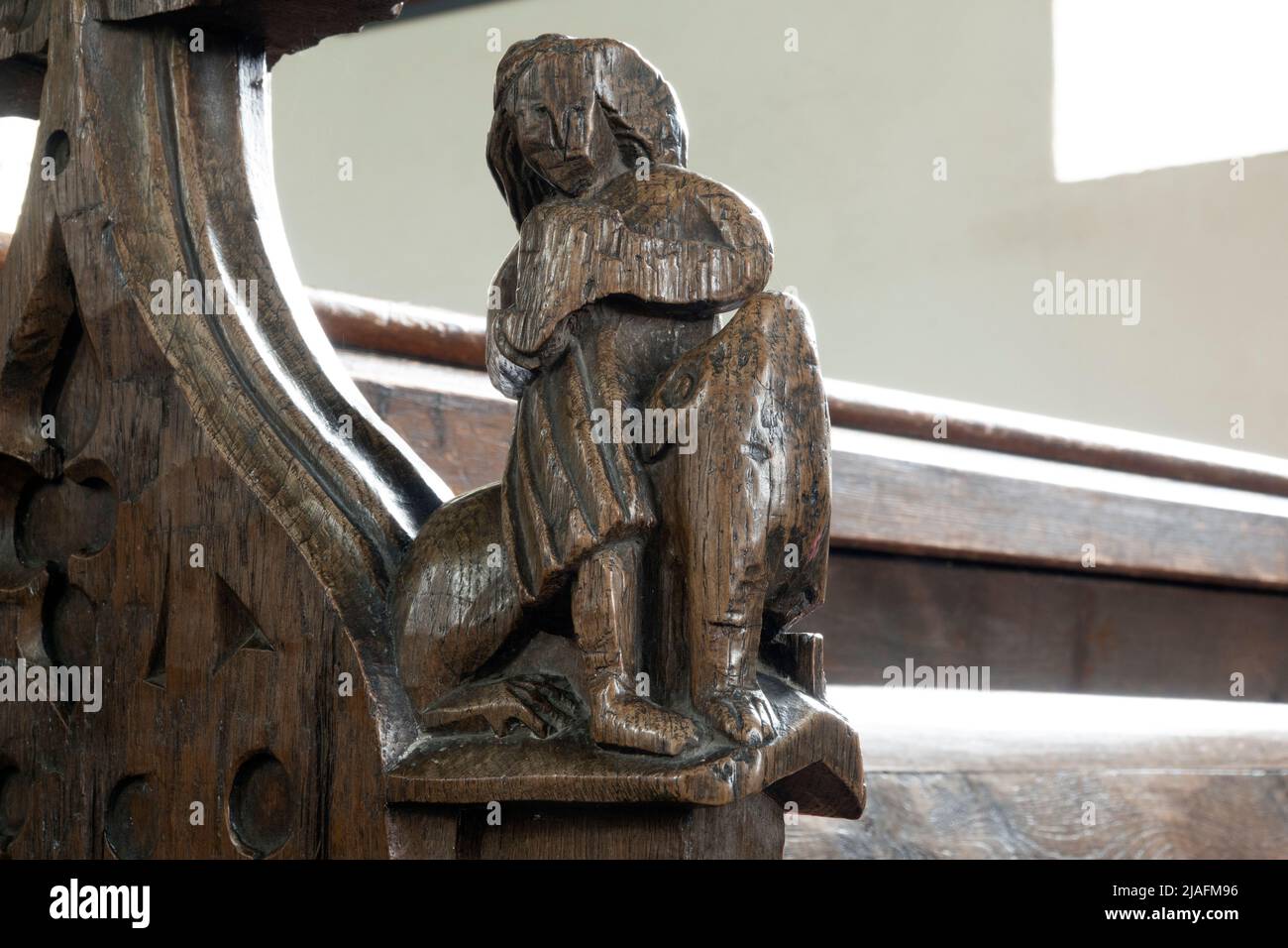 15th century carved wooden bench end at All Saints Church, Brandeston, Suffolk Stock Photo