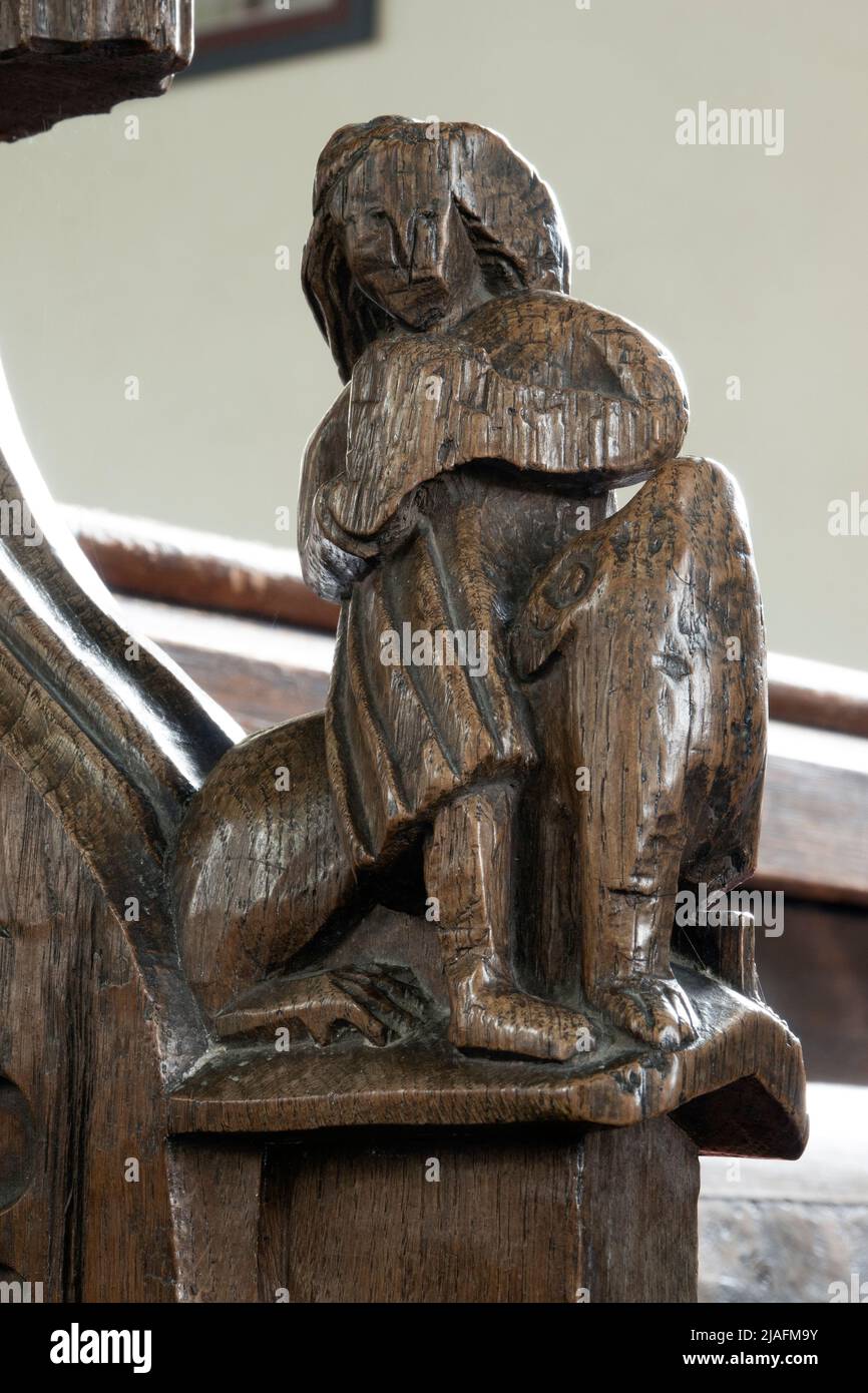 15th century carved wooden bench end at All Saints Church, Brandeston, Suffolk Stock Photo