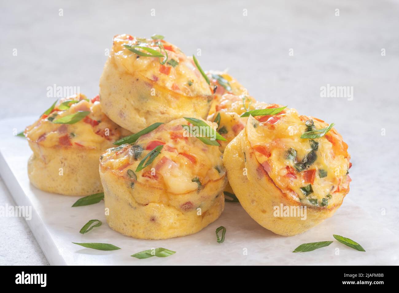 Delicious egg muffins with ham, cheese and vegetables Stock Photo
