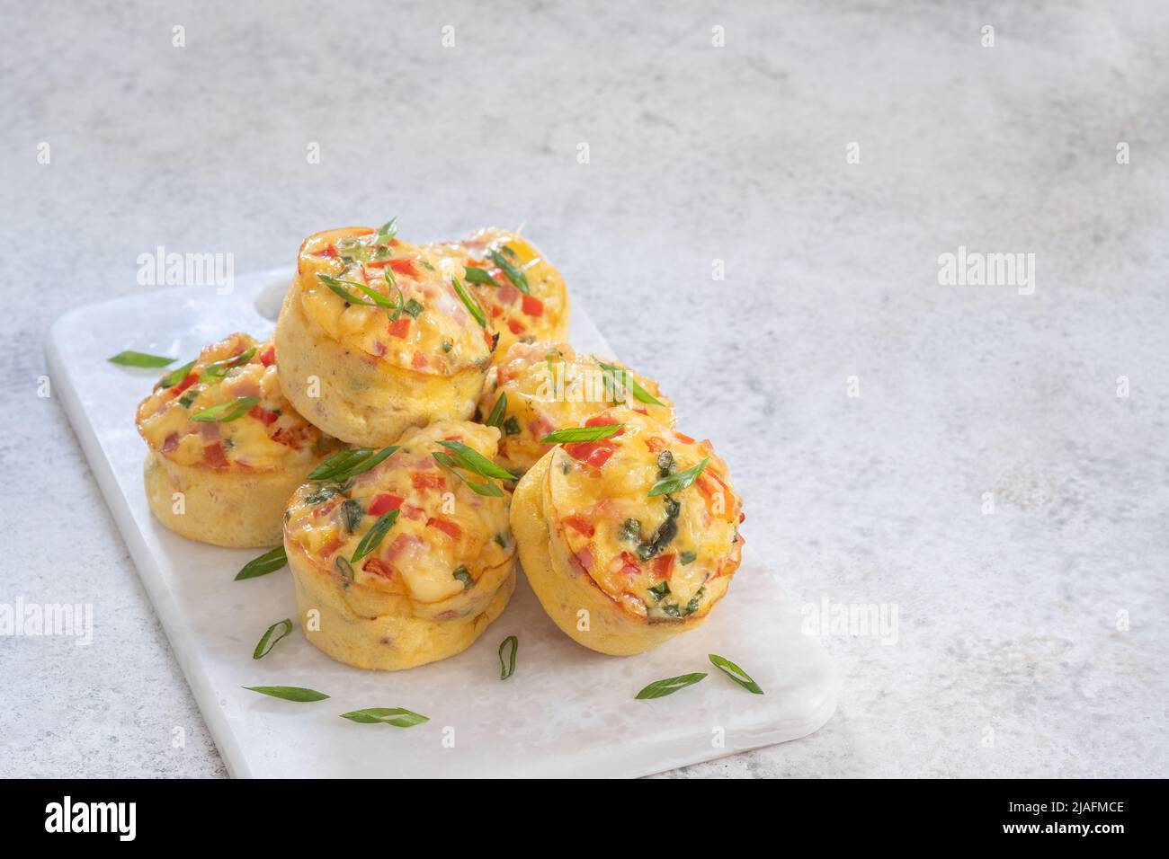 Delicious egg muffins with ham, cheese and vegetables Stock Photo