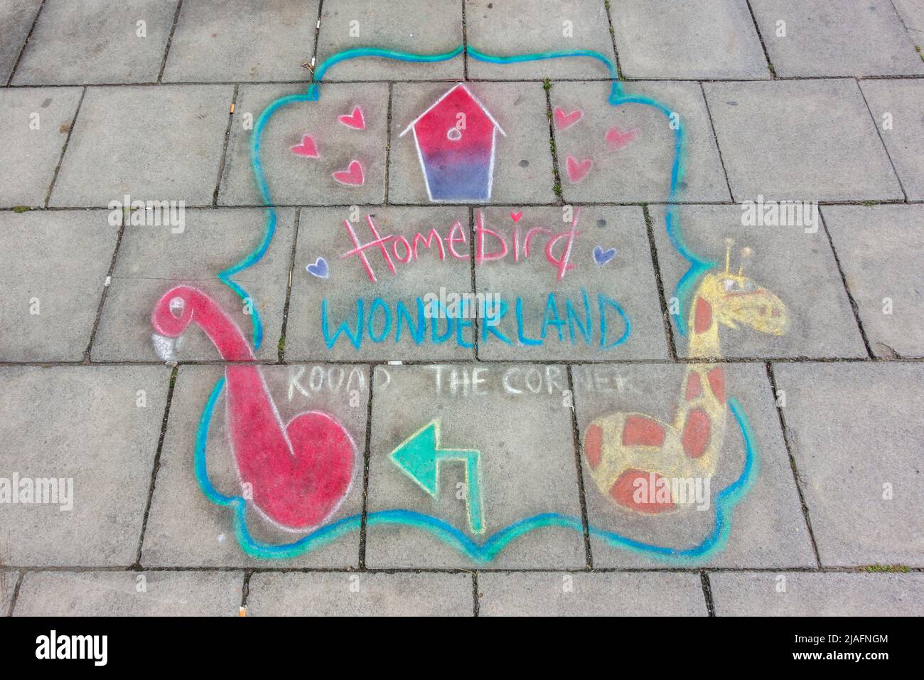 Advert for Homebird Wonderland drawn on the pavement in Scarborough, North Yorkshire, UK. Stock Photo