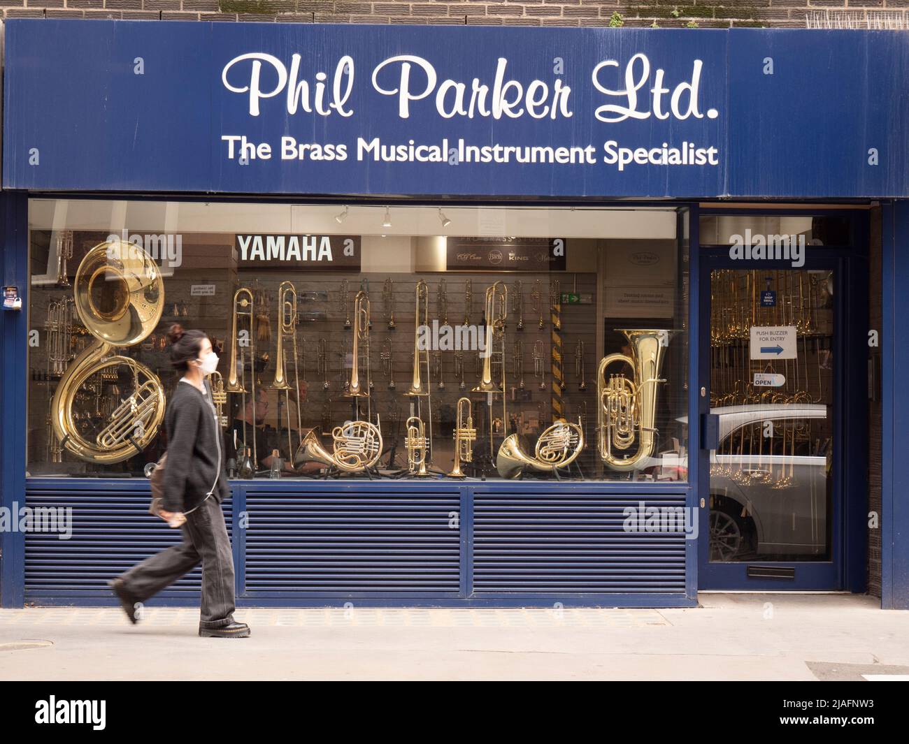 display in window of Phil Parker the brass musical instrument specialist shop in central London UK Stock Photo