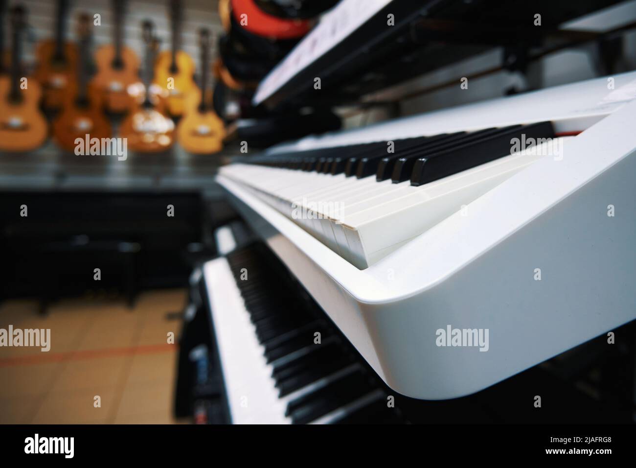Modern electronic keyboard synthesizers in a music store. Digital pianos in store Stock Photo