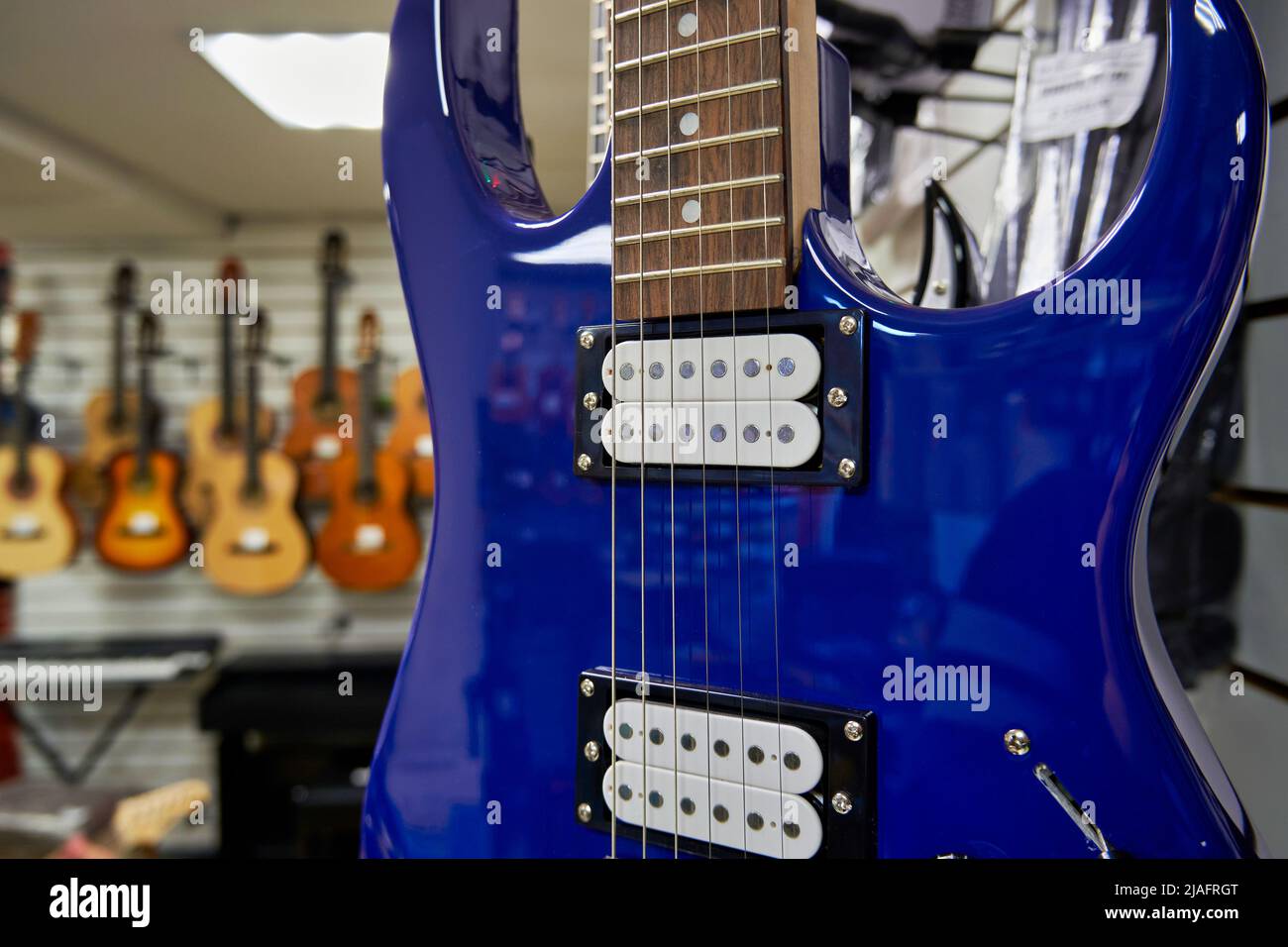 Blue electric guitar in a guitar shop close up Stock Photo Alamy