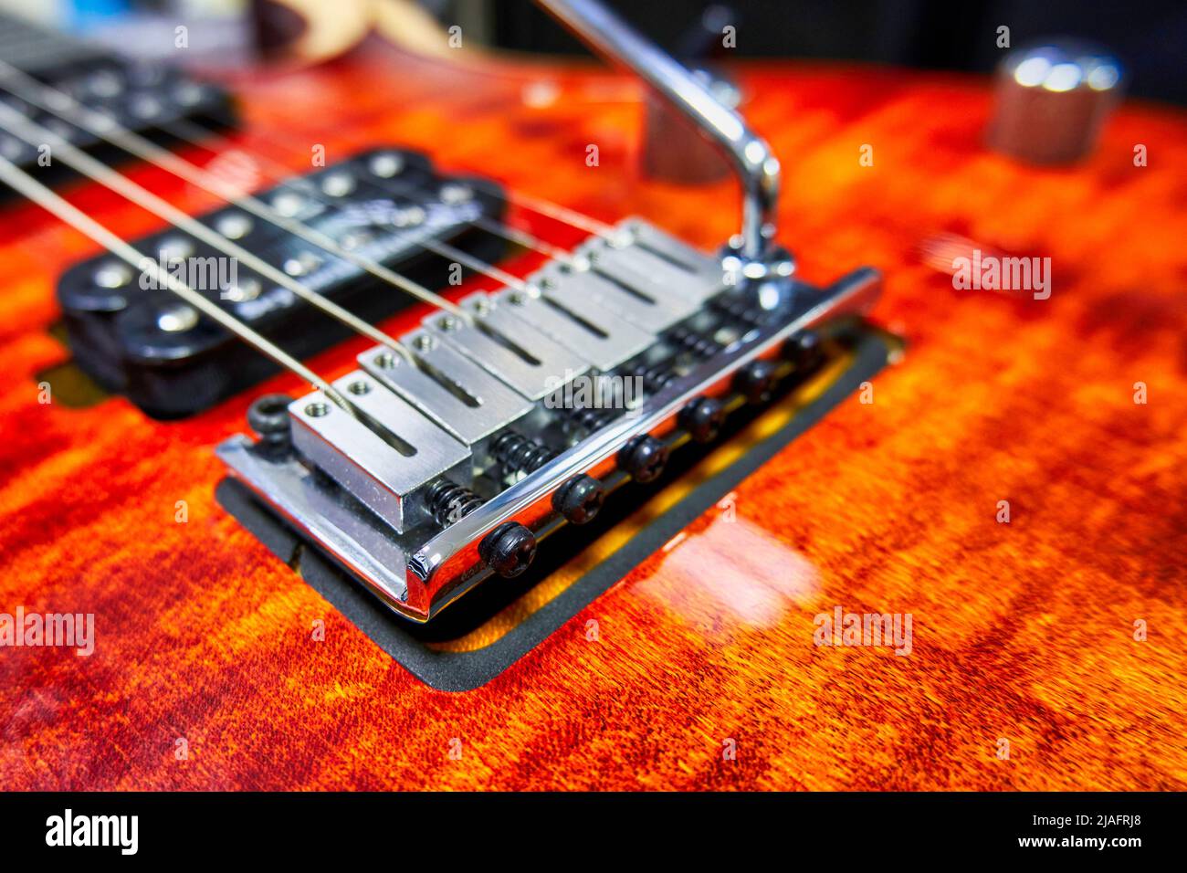 Electric guitar bridge close up. Guitar deck with chrome parts Stock