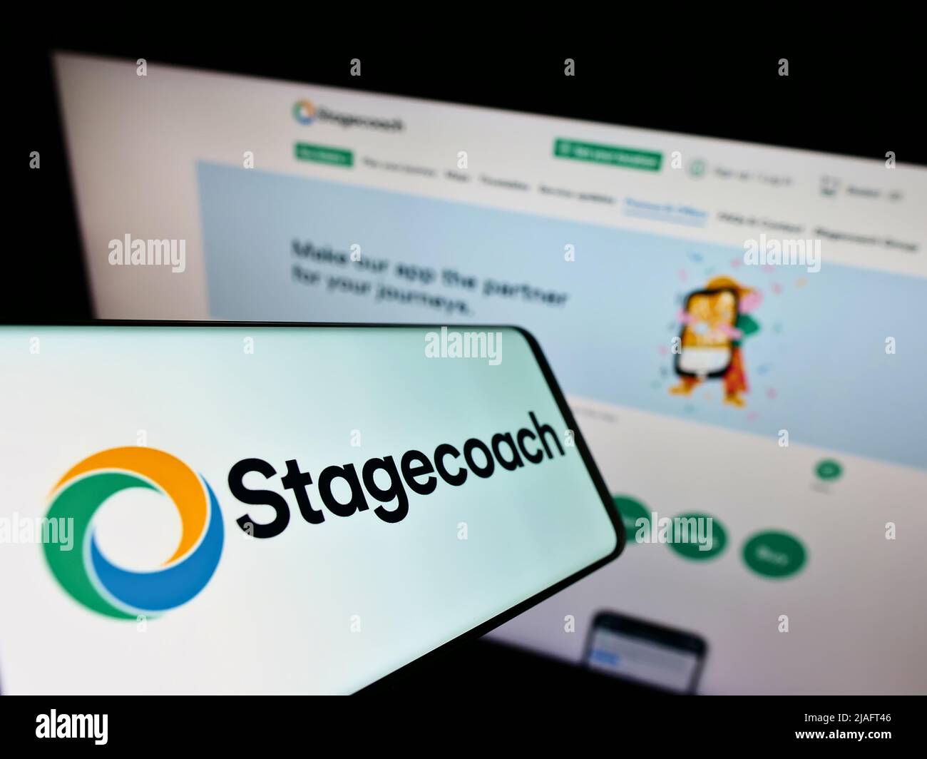 Smartphone with logo of British bus company Stagecoach Group plc on screen in front of business website. Focus on center of phone display. Stock Photo