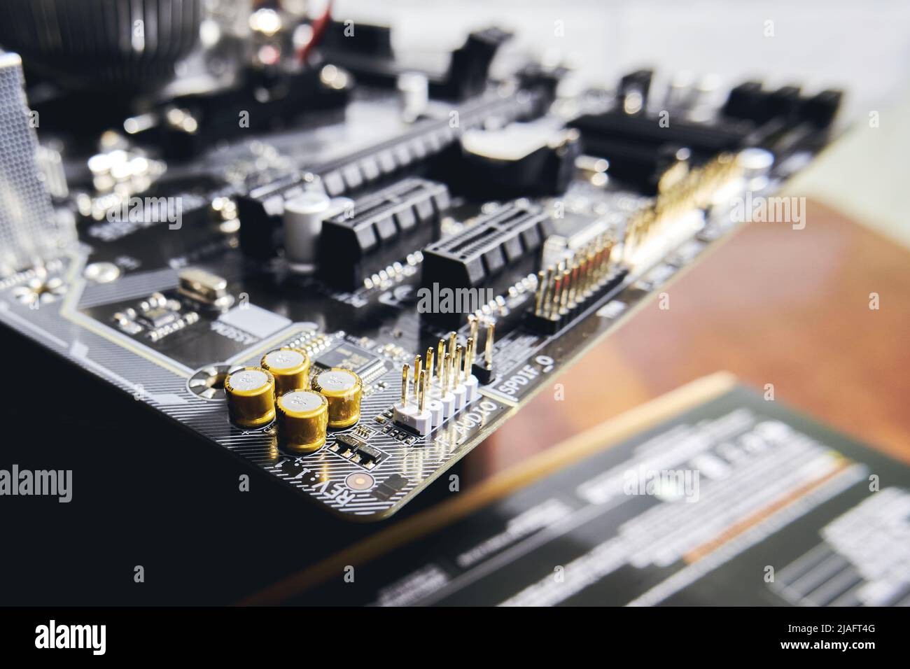 Goldplated capacitors and connectors on the motherboard of a modern personal computer Stock