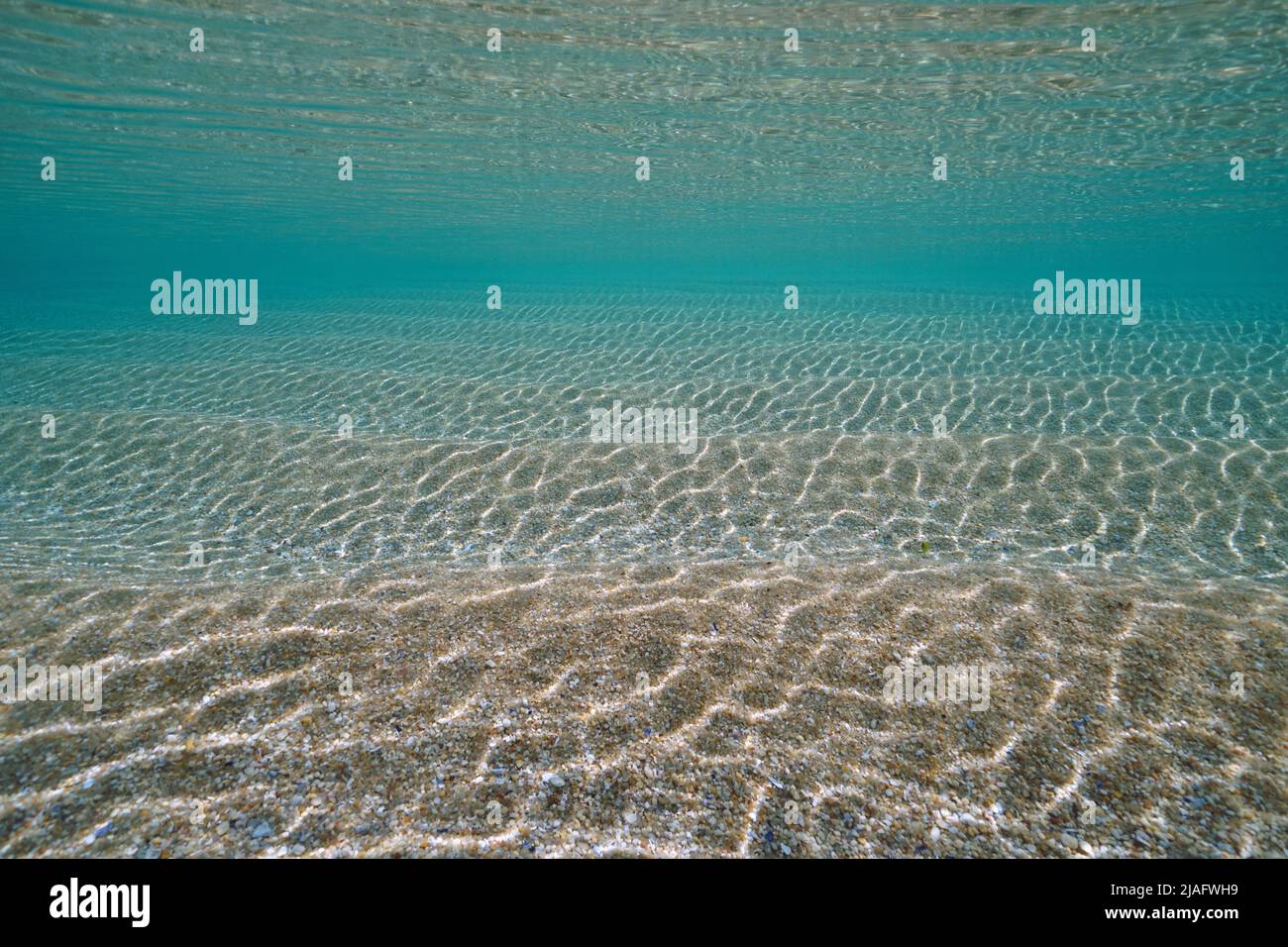 Ripples of sand underwater below sea surface with clear water, natural sandy ocean floor, Atlantic ocean, Spain Stock Photo
