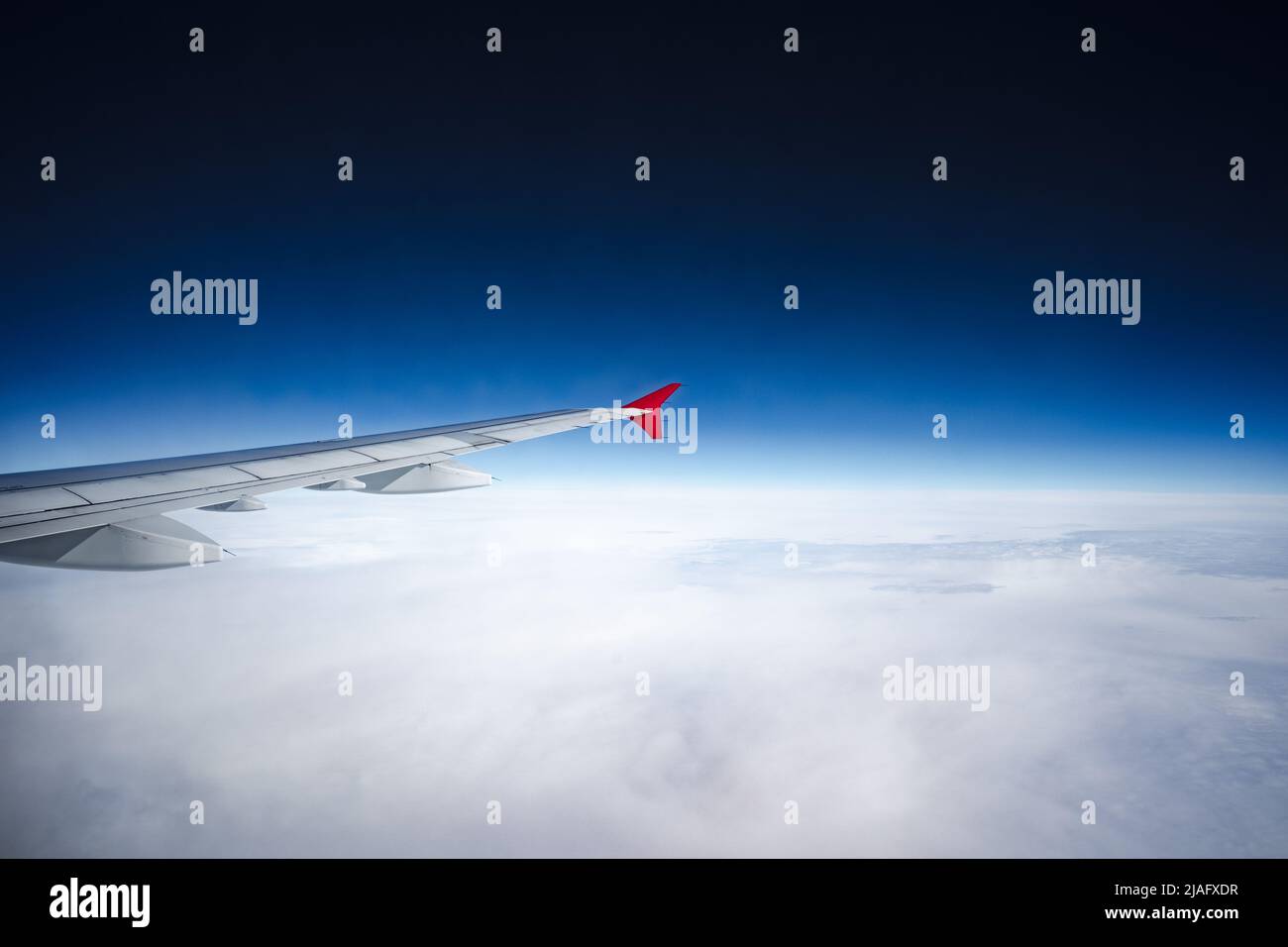 Aircraft wing above beautiful clouds and blue sky Stock Photo - Alamy