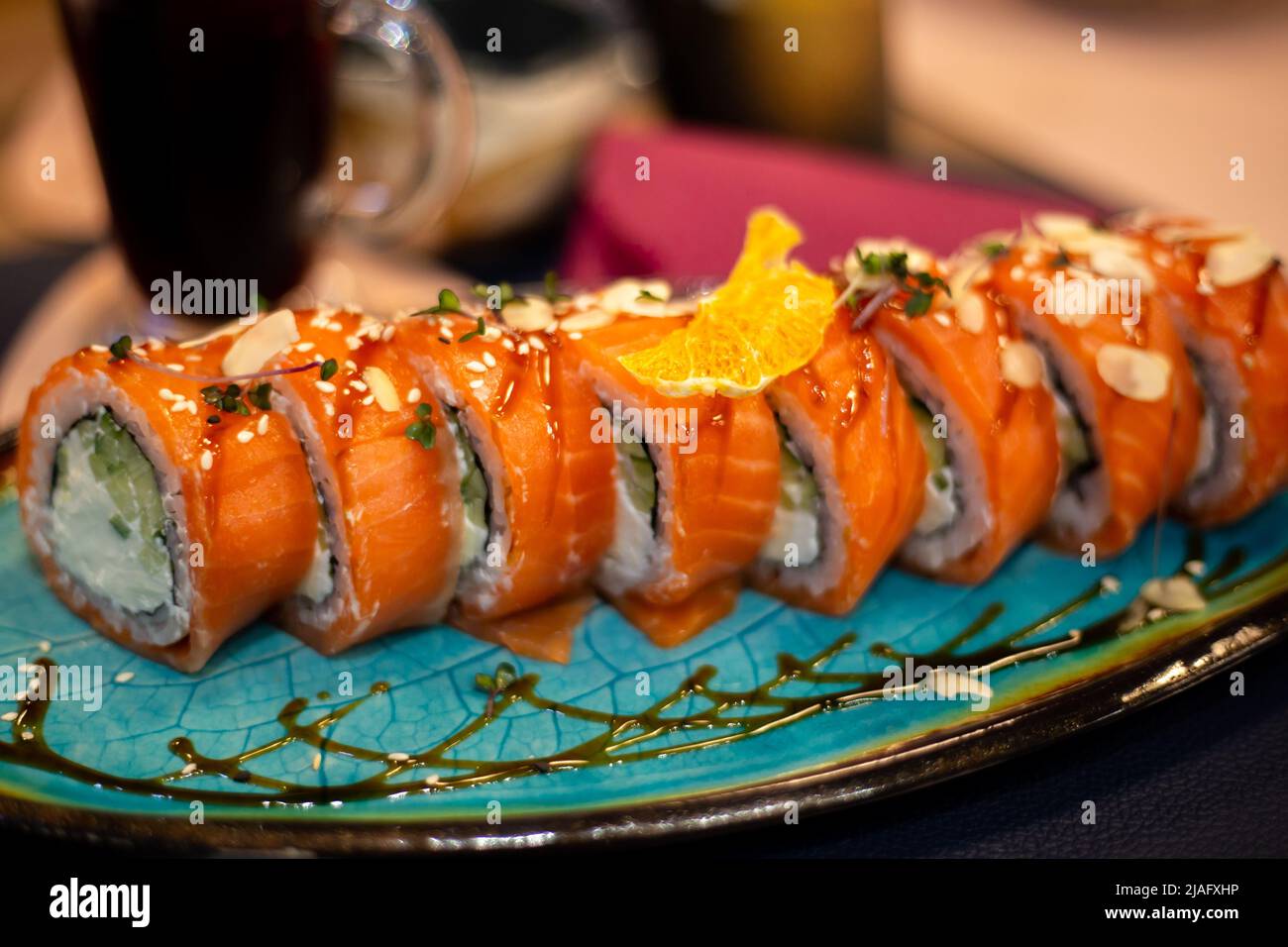 Asian food sushi and rolls with white cream cheese wrapped in red fish Stock Photo