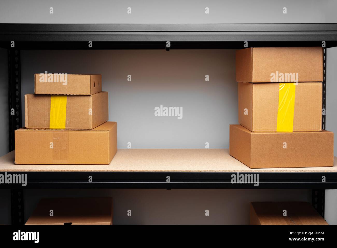 Rows of shelves with cardboard boxes in modern warehouse Stock Photo ...
