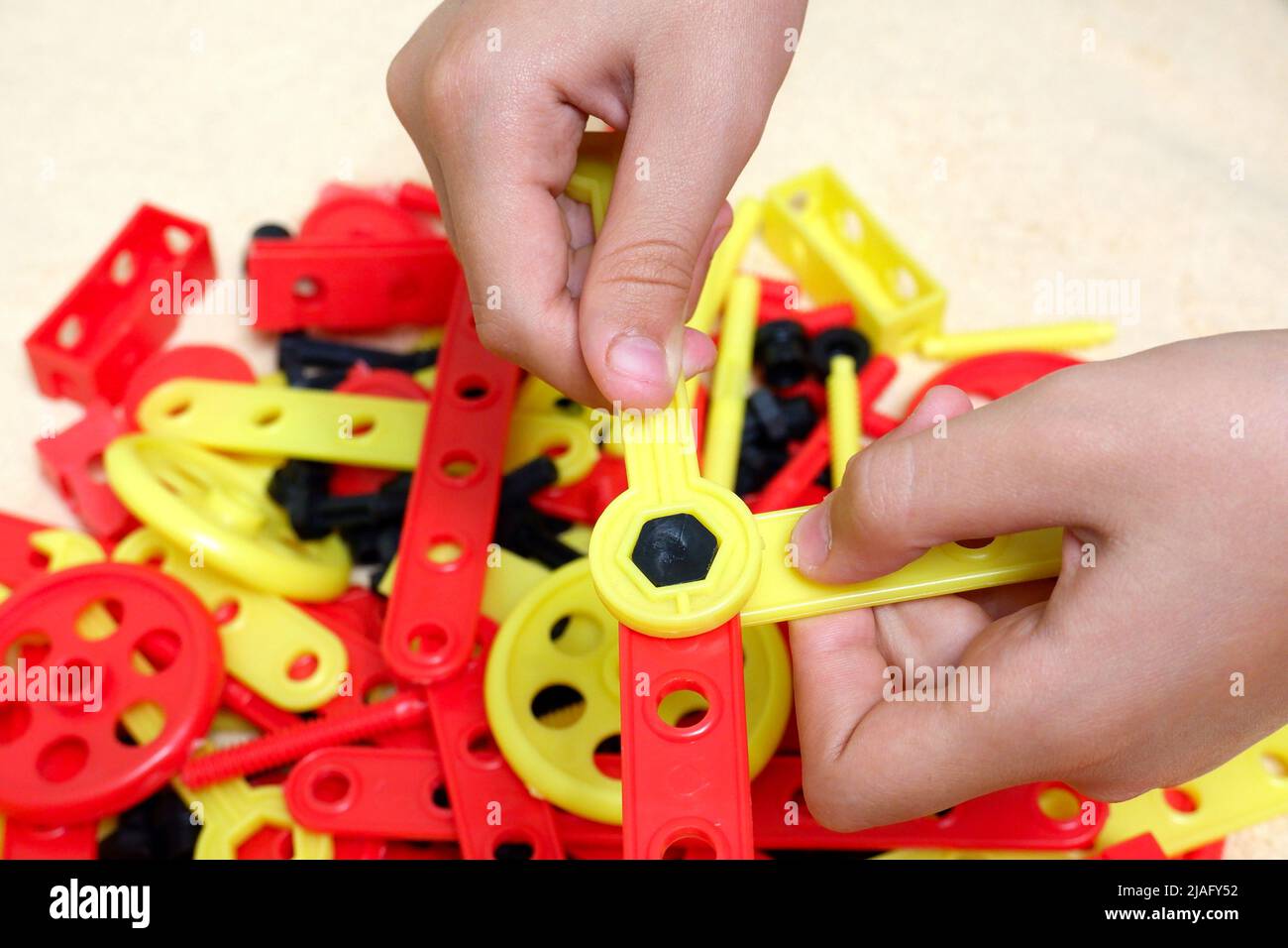 Child's hands with creative kit assembly tool Stock Photo - Alamy