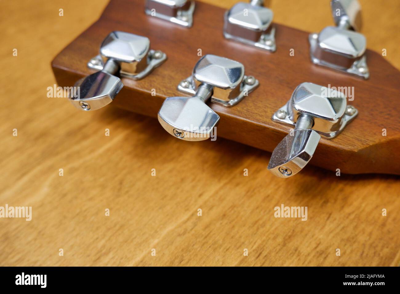 Acoustic guitar headstock. Guitar tuning pegs, spot focus Stock Photo