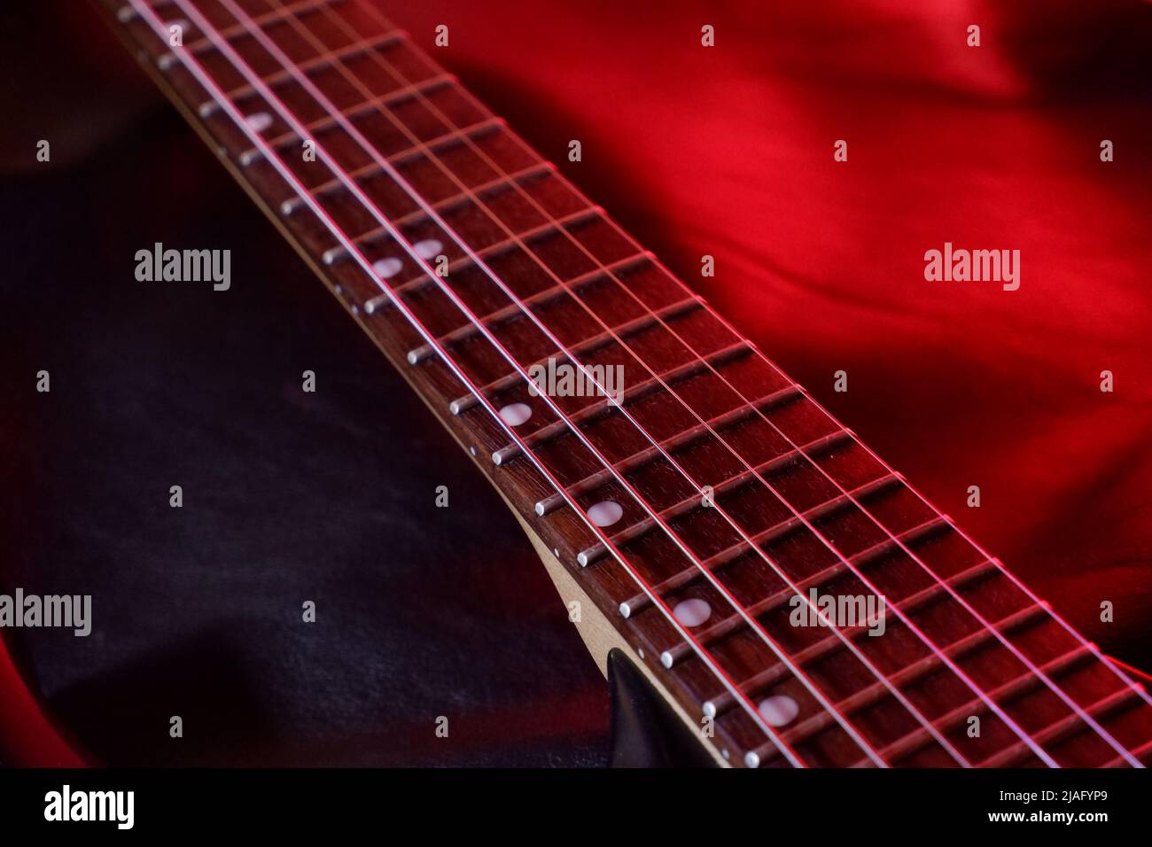 Guitar fretboard illuminated by red light Stock Photo Alamy
