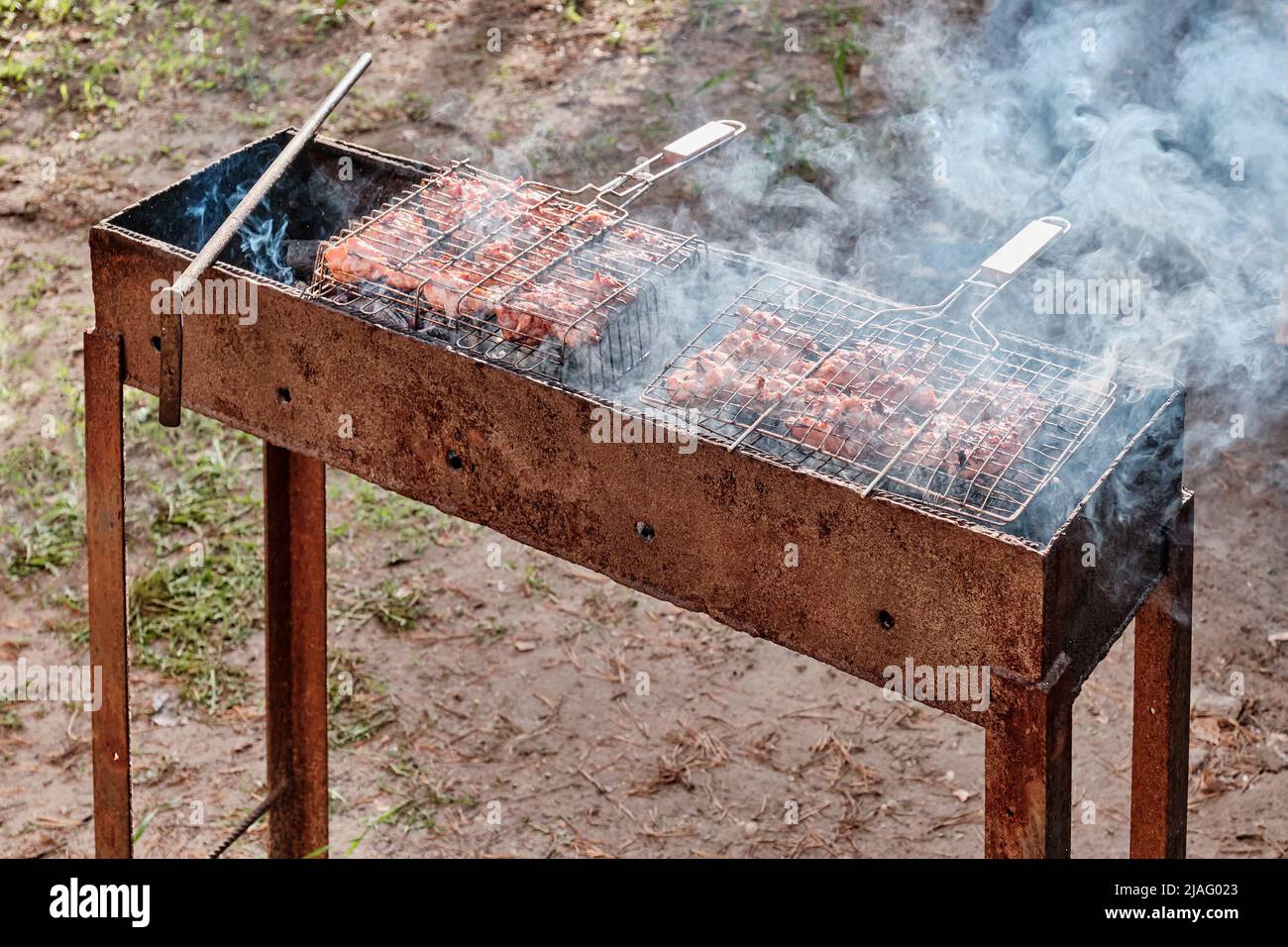Chicken meat is cooked on barbecue grill in backyard Stock Photo - Alamy