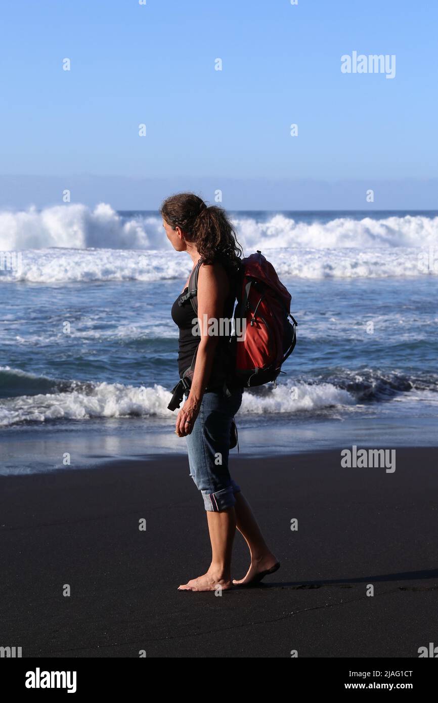 Woman walking on the beach near Puerto de la Cruz in Tenerife Stock Photo