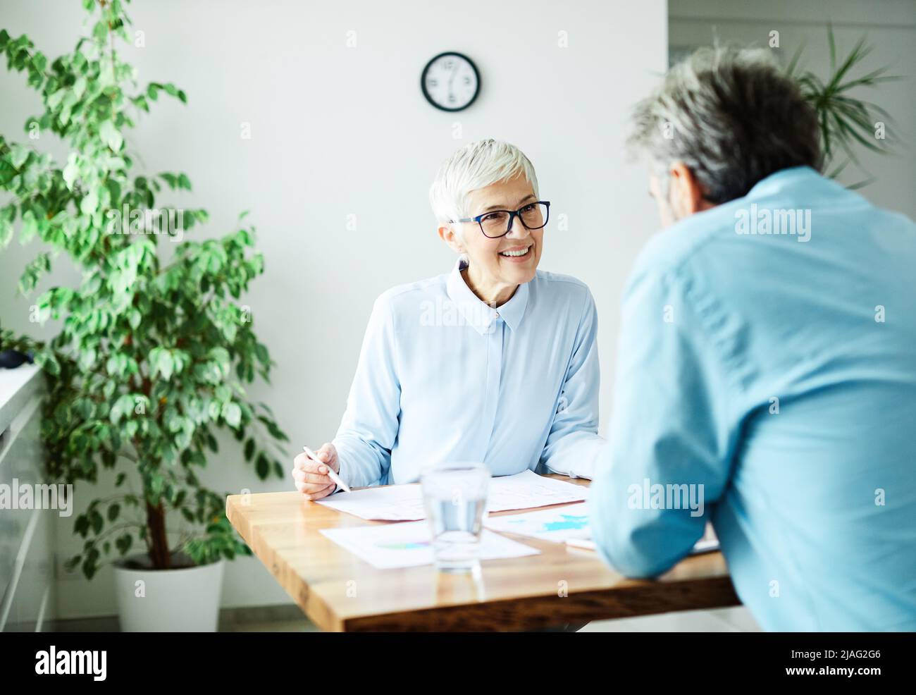 business office discussion teamwork senior meeting businesswoman colleague woman vitality elderly Stock Photo