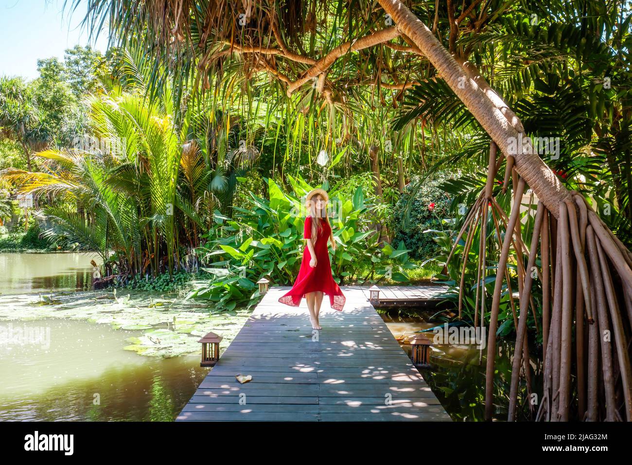 Asian girl walking in tropical park Stock Photo - Alamy