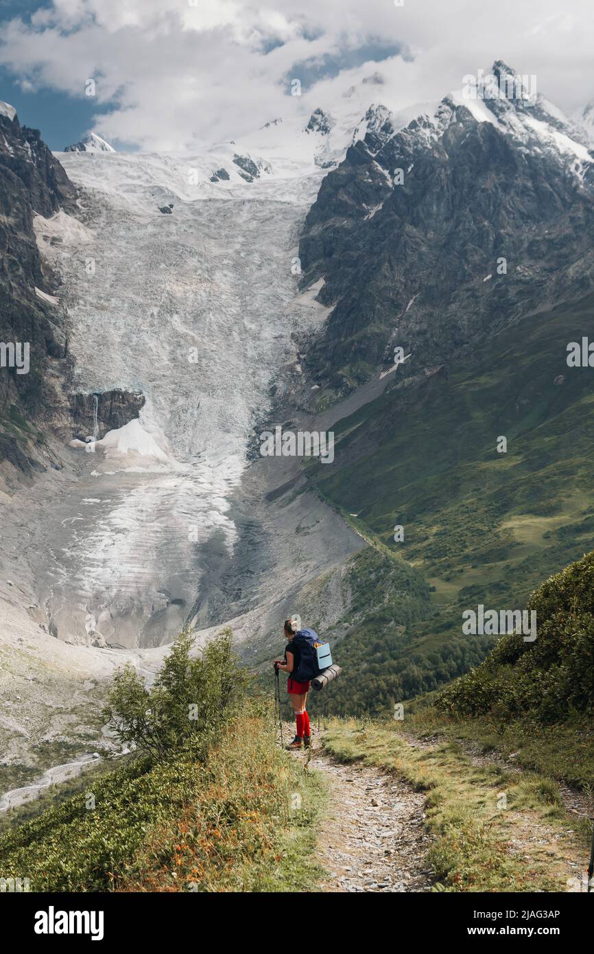 Young active girls hiking in Greater Caucasus mountains, Svaneti region, Mestia district, Svaneti, Georgia Stock Photo