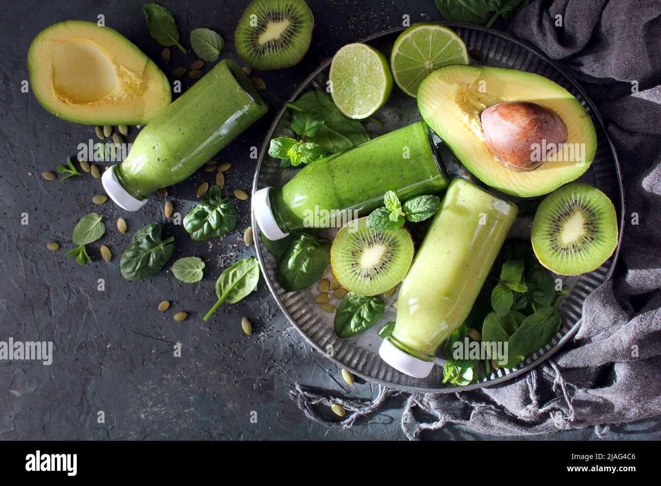 Fresh green avocado smoothie with spinach and kiwi on the table. Top