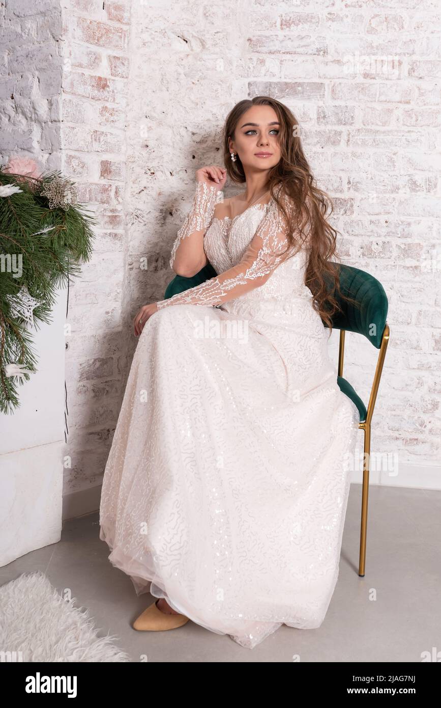 The bride in a white dress sits on a chair. High quality photo Stock ...