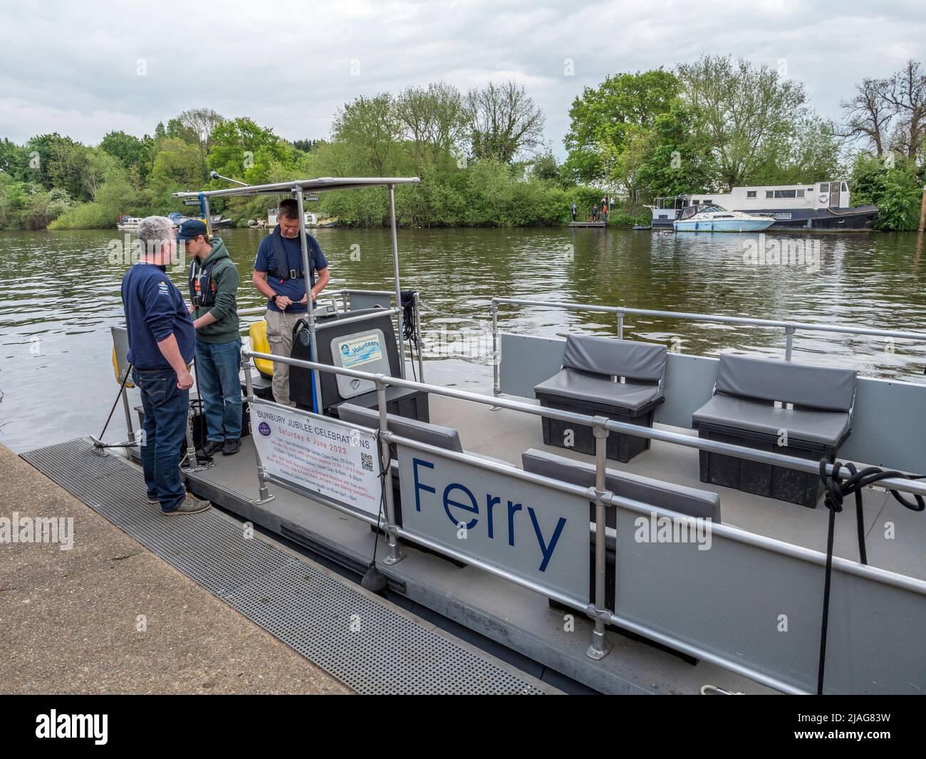 Passengers embarking on the Sunbury Ferry on the River Thames in Hampton, West London, UK. Stock Photo